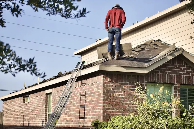 Professional roofer working on a residential roof in Locust Manor